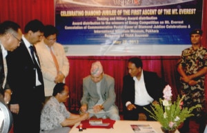 Minister affixing the first cancellation mark on the stamp. Photo: Nepal Mountain Focus