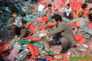 Chinese workers tak apart electronic trash on the street in Guiyu, China.