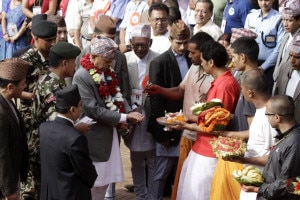 President Dr. Ram Baran Yadav receiving prasad from the hands of priests at the Shree Krishna Mandir premises during his visit to the Temple at Patan on Wednesday, August 28, 2013. The head of the state also paid homage to Lord Shree Krishna on the occasion. Photo: Courtesy to RSS