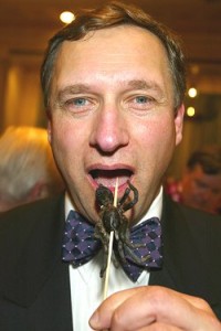 David Hemplemen Adams is tempted by the glazed- tarantula hors d'oeuvres on offer at the Explorer's Dinner in New York 2004. Photo: Stuart Conway - The Telegraph