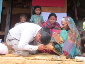 In this photo made public by National News Agency RSS, a candidate representing from United Maoist party tries to seek a favor of an elder in a remote village in Gulmi district, around 300 kilometer west of the Capital Kathmandu.