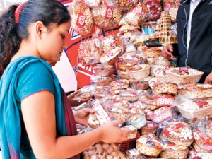 A shopper buying dry fruits for Tihar at a shop in Ason, the central market place in Kathmandu. Photo: NMF