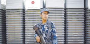 A security officer of Nepal Police stands by the pile of ballot boxes in the premises of Election Commission in Kathmandu. Photo: NMF 