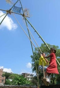 Two girls enjoying swing. Playing swing and flying kites are the integral  part of Dashain festival. Photo: File photo