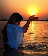 A devotee offering prayer to setting sun, file photo.