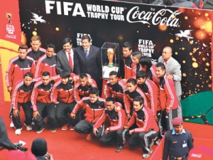 Nepali national football team members posing for a photograph with the trophy. 