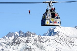 The crew watches on as Mr Millot balances precariously on the thin wire hundreds of feet above the Alps. Photo: dailymail.com