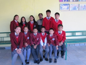 Students pose for photo with hostel warden. Photo: NMF.