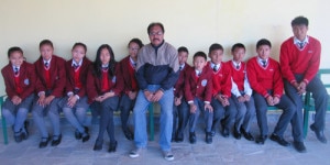 Students pose for photo with their hostel warden KB Thapa (center). Photo: NMF