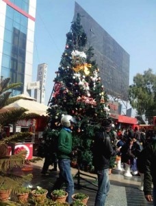 People walk by a X-Mas Tree set at the premises of a shopping mall in Kathmandu. Photo:NMF 