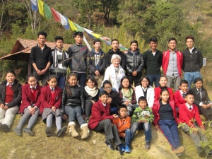 Fabienne Clauss with children studying under the Foundation pose for a group photo during a picnic organized in Kathmandu on January 15. Photo: NMF