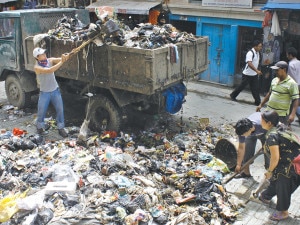 Staffs of the Kathmandu Metropolitan City collecting garbage from a street in Kathmandu. Photo: File photo 