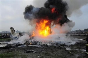 Rescue team members douse a Dornier aircraft that caught fire after it crashed in Kathmandu September 28, 2012. Image: Reuters.