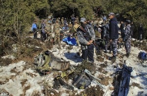 Nepalese security officers scrutinize the wreckage of Nepal Airlines' Twin Otter crash site at Masine hill in western Nepal on February 17. Photo: AP