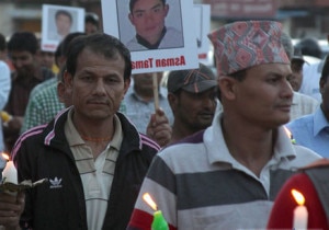 Tourism entrepreneurs participate in a candle rally on the eve of Everest Day holding portraits of April 18 avalanche victims in Kathmandu, Wednesday.