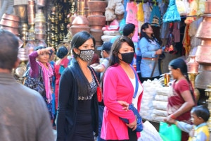 Pedestrian wear mask at a busy street in Kathmandu. Image: agency