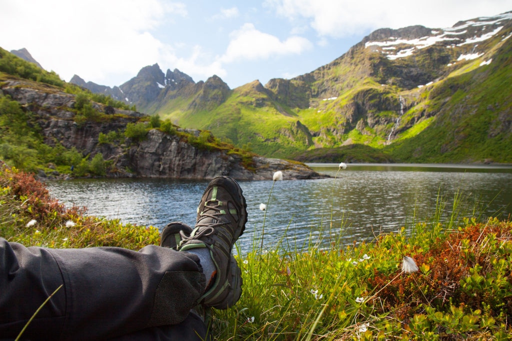 Hiker relaxing near mountain lake, Lofoten, Norway; Shutterstock ID 291947180