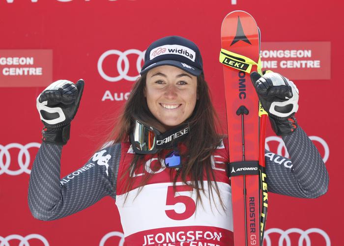 epa05828298 Winner Sofia Goggia of Italy celebrates on the podium after the women's downhill race of the FIS Alpine Ski World Cup in Jeongseon, Gangwon-do, South Korea, 04 March 2017. EPA/JEON HEON-KYUN