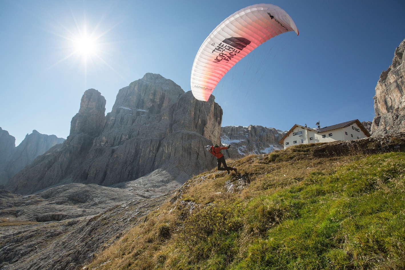 Hansjörg Auer fly off from Rif. Pisciadu towards Sass dla Crusc, Italy.