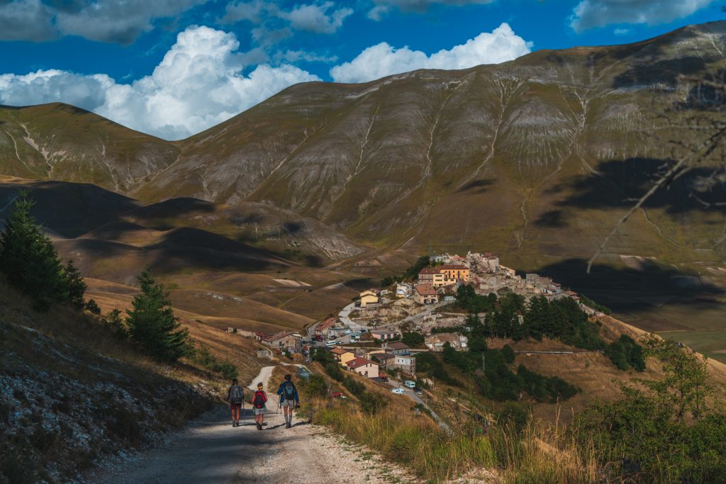 Il borgo di Castelluccio, nella sua desolazione post sisma, si scorge alla fine del sentiero che parte da Norcia. Foto Sara Furlanetto