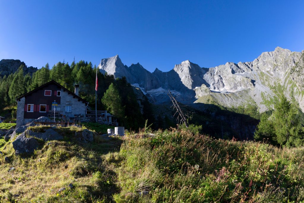 La capanna Sasc Furä (1904 m) con alle spalle le pareti nord del Badile e della Punta Sant’Anna. Foto S. Caldera/Clickalps