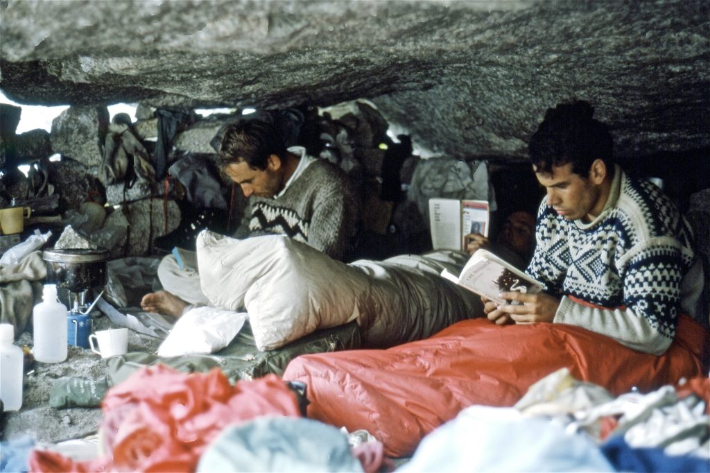 Doug Tompkins and Yvon Chouinard in sitting up in sleeping bags reading. (Lito Tejada-Flores/Patagonia)