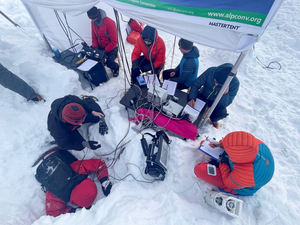 Partecipante a faccia in giù nella neve, con cablaggi collegati ai monitor per consentire il monitoraggio dei parametri vitali. Il team di ricerca è pronto a intervenire @ Eurac Research Metadata